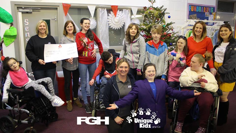 Staff from FGH present Unique Kidz and Co with cheque